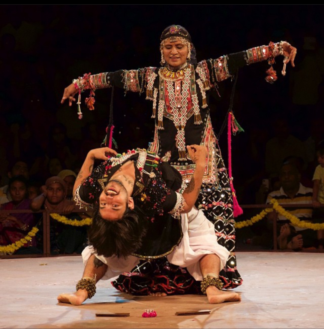 Kalbelia dancers in traditional black costume with silver embellishments