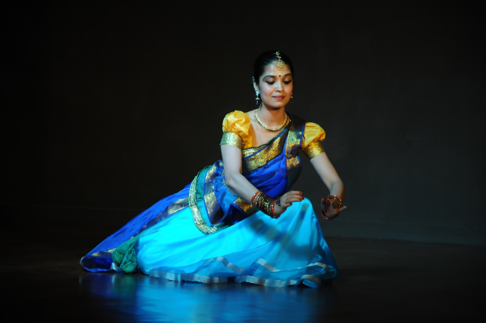 Professional Kathak dancer in traditional North Indian costume with graceful pose