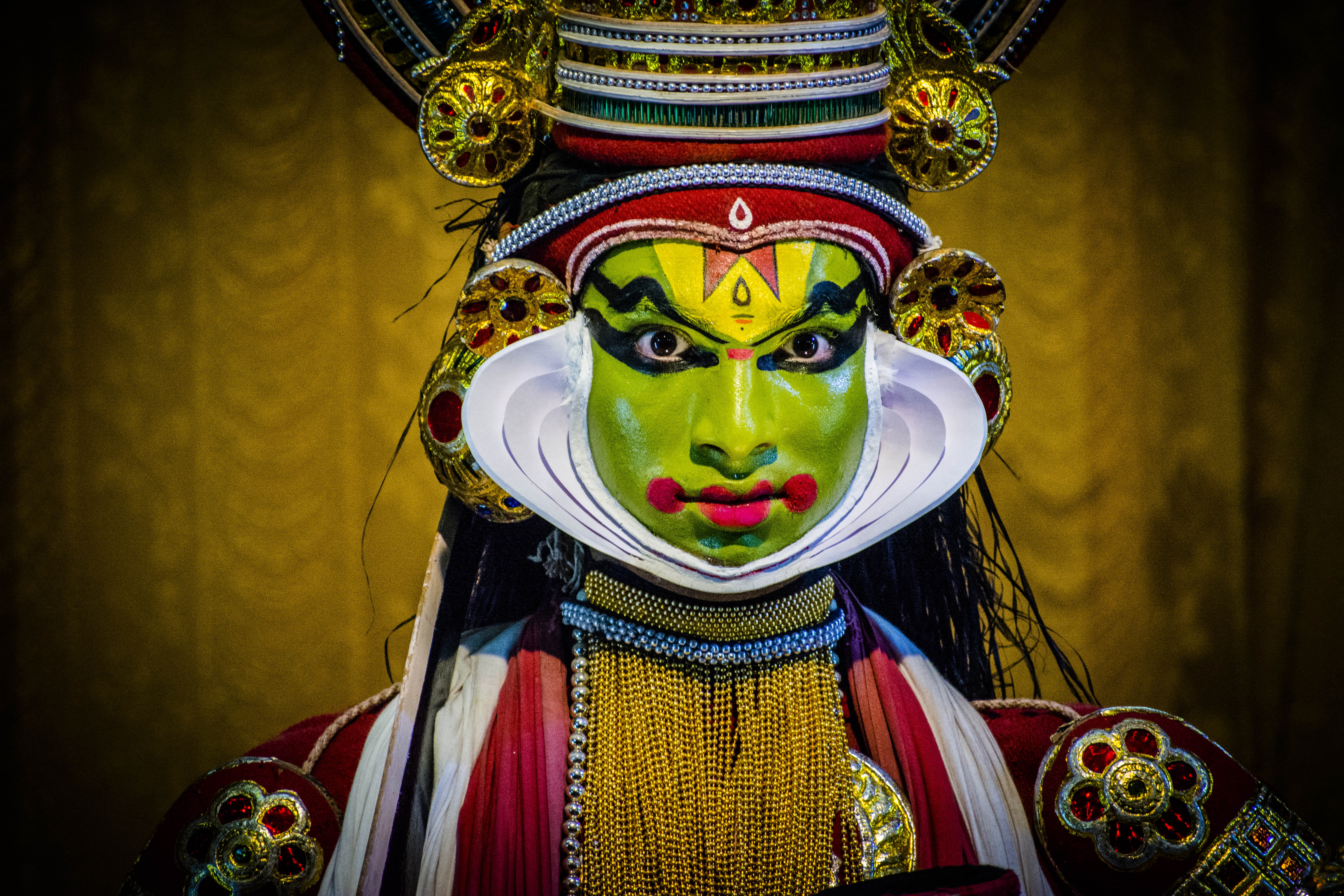 Kathakali dancer performing at cultural event with traditional costume