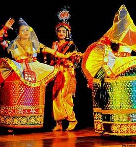 Manipuri dancer in traditional Krishna attire performing devotional dance