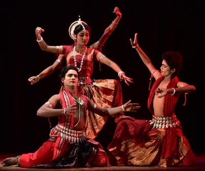 Solo Odissi dancer performing devotional dance in traditional setting
