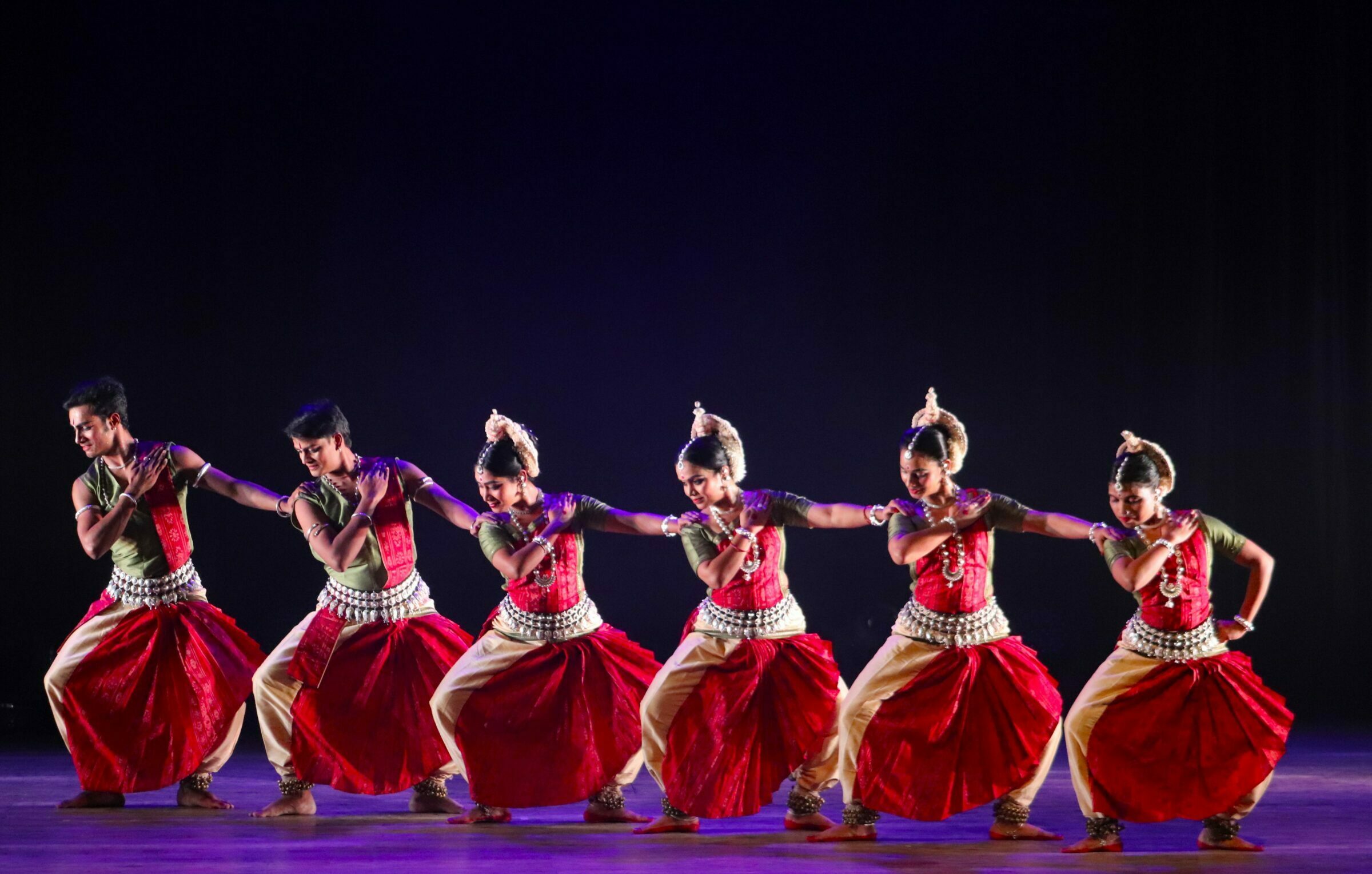Odissi dancer in elegant pose with temple jewelry and traditional attire