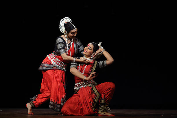 Odissi dancer performing devotional dance on stage