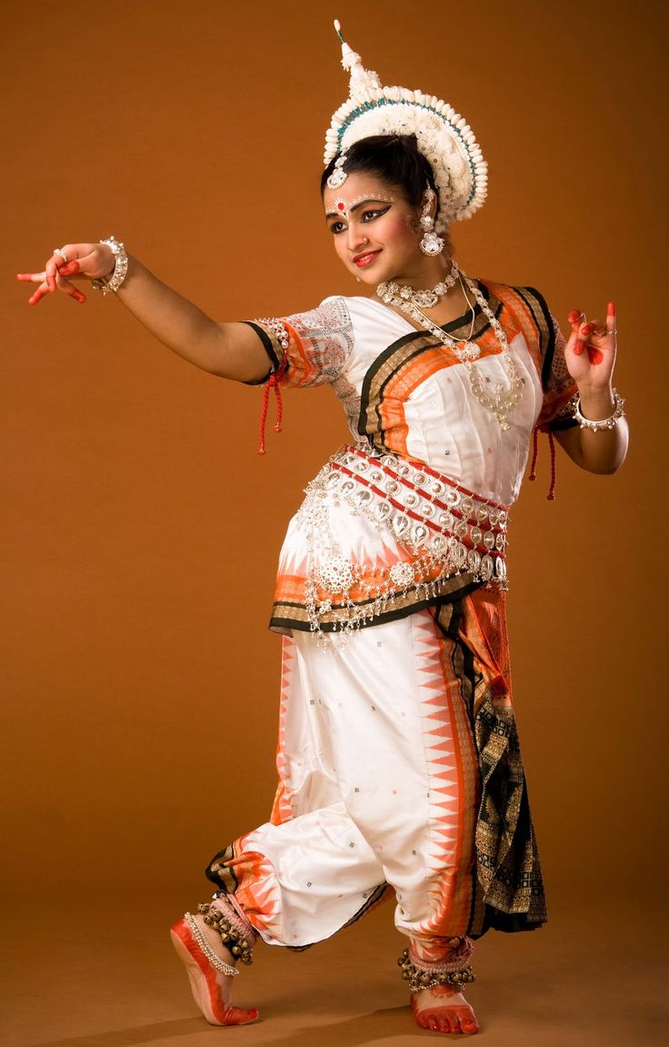 Odissi dancer performing Tribhanga pose at cultural festival in India