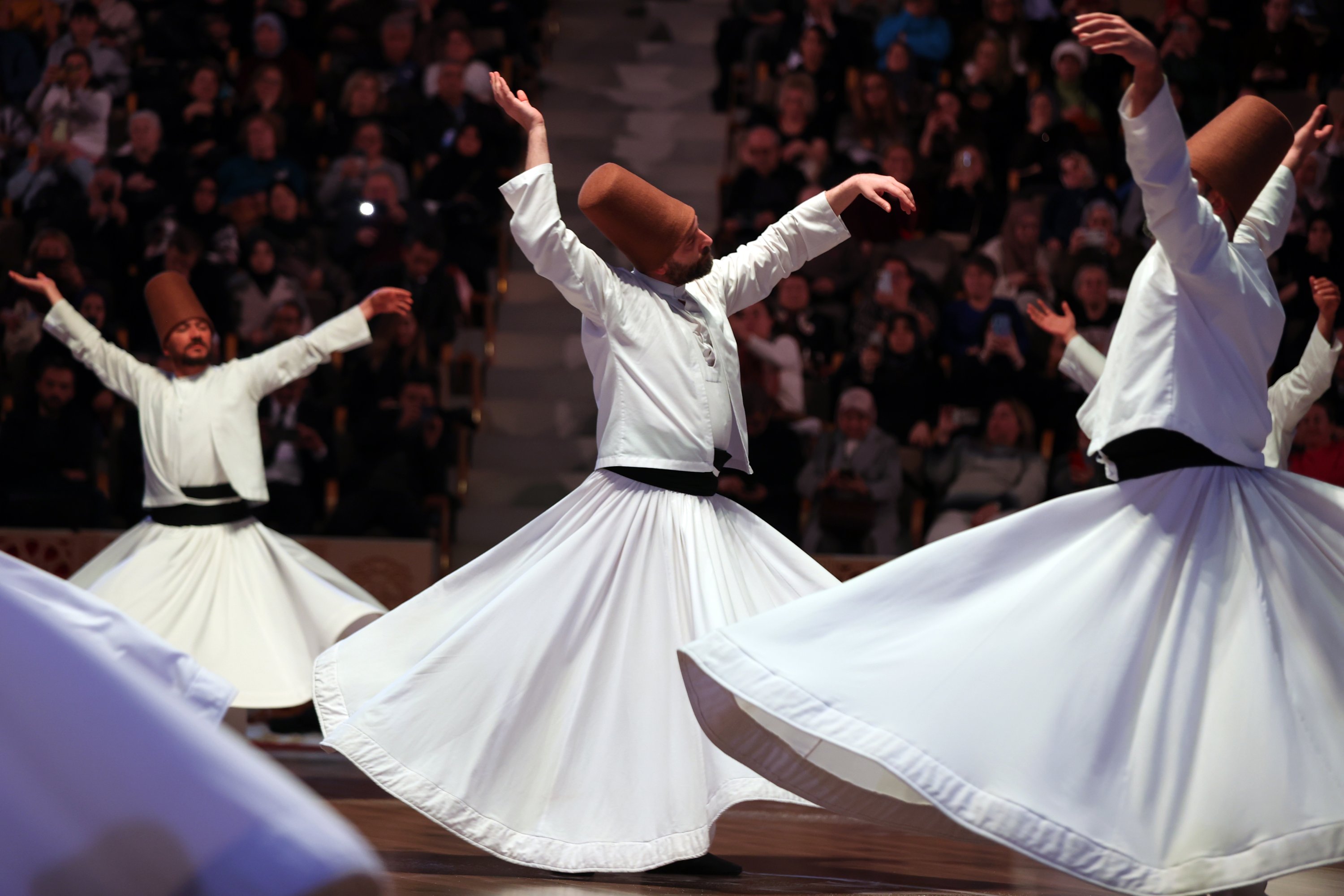professional sufi whirling dancer performing on stage